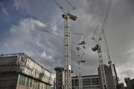 A low angle shot of cranes in an architectural place