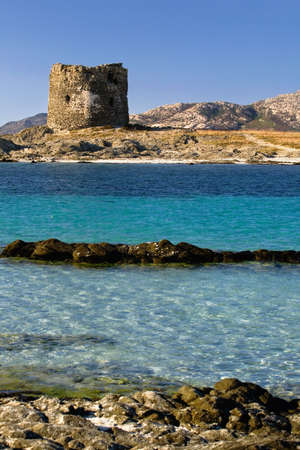 A beautiful view of Pelosa Tower at Stintino, Sardinia, Italy on a sunny dayの写真素材