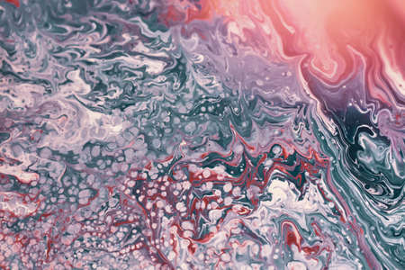 An overhead shot of a mixed pink and blue liquid - background concept