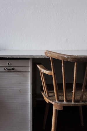 Vintage chair with the desk and white wall