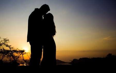 A silhouette of a couple kissing at the sunset in Hartbeespoort, South Africaの写真素材