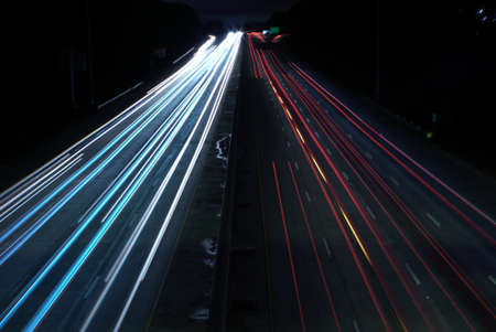 An overhead shot of a highway road with car light speed trailsの写真素材