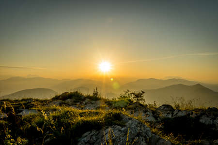 A beautiful shot of the sun over the mountain Misma in Bergami in Northern Italyの写真素材