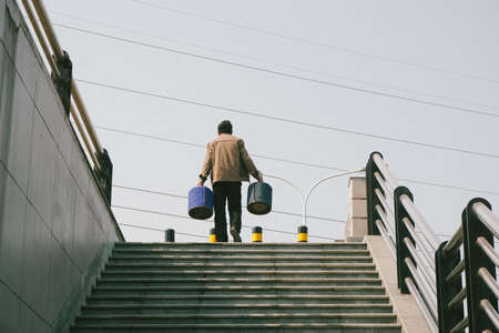 A man on the staircases under the electric cordsの写真素材