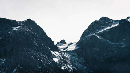 A beautiful shot of rocky and snowy mountains with amazing clear sky in the background