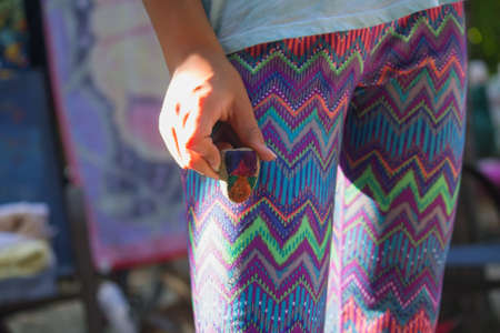 A closeup of female holding a painted rockの写真素材