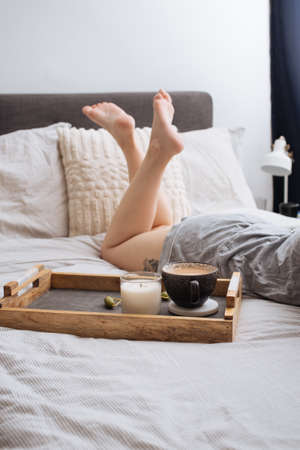 A beautiful shot of morning coffee in bed - morning laziness conceptの写真素材
