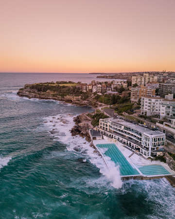 Beautiful aerial shot of a coastal city and the sea at dawnの写真素材