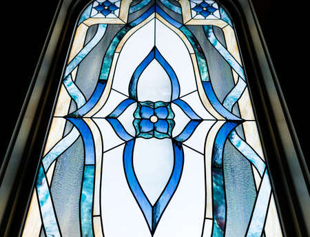 A low angle closeup shot of a beautiful decorative window at a churchの写真素材