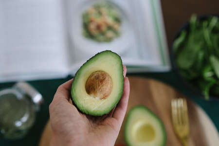 a closeup of a person holding an avocado