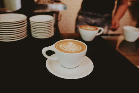 A closeup shot of a beautifully made cappuccino with flower foam art