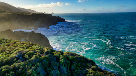 The beautiful aerial photography of the shoreline of the sea with amazing waves on a sunny day