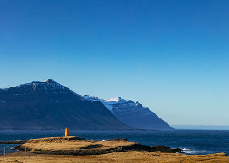 Beautiful shot of mountains and the sea from the coast with clear blue skyの写真素材