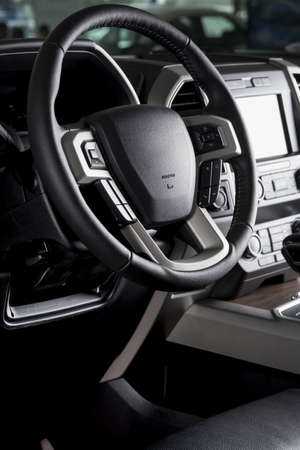 A vertical shot of leather-covered steering wheel of a new SUV carの写真素材