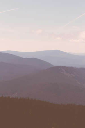Beautiful layers of hills with trees shot from above with