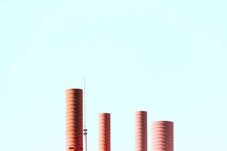 The metal pipes of an old factory with a clear blue sky in the backgroundの写真素材