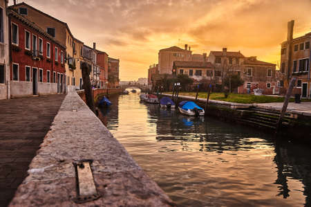 Perspective view of a canal in Venice, Italy, at sunsetの写真素材