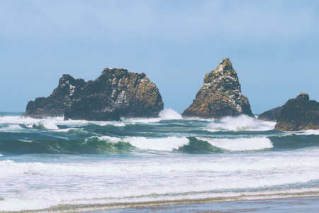 The beautiful rocks on the coast of the sea with blue sky in the background