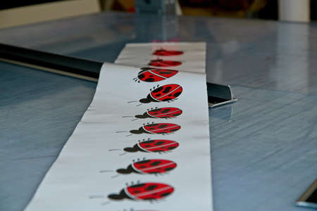 A closeup shot of white tape with ladybugs on the table