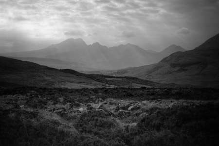 Beautiful mountains and hills with breathtaking cloudy skies shot in black and white