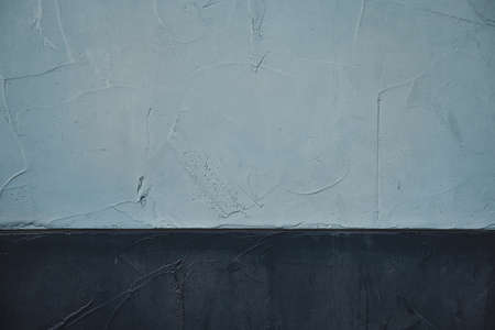A closeup shot of a painted gray and dark blue wall backgroundの写真素材