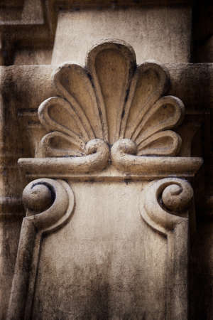 A closeup of a decorative stone pillar with a grungy filter