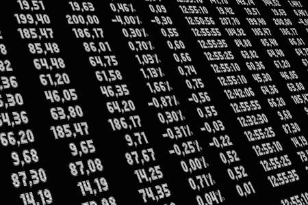 A low angle shot of a financial chart with numbers on a black screen