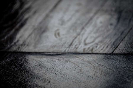 A closeup shot of a wooden surface in black and white