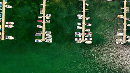 An ariel overhead shot of boats at the dock on a sunny day