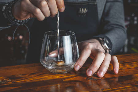 Barman making and serving a cocktailの写真素材