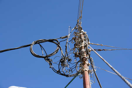 A pole with a lot of cables and joints