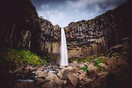 A beautiful waterfall in Svartifoss and mountains with amazing textures.