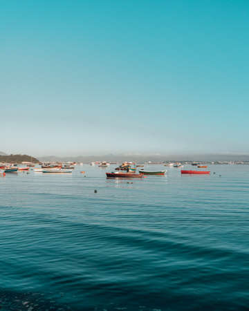 Many fishing boats on the water with clear beautiful skyの写真素材