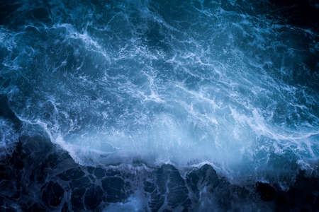 An aerial beautiful shot of sea waves with amazing water textures in the focus