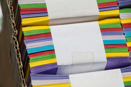 A lot of colored papers in a carton box