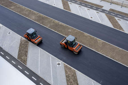 A high angle view of road-rollers on the fresh asphalt at daytime