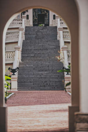 A stone stairway leading to a palace shot from an arch opening near the entranceの写真素材