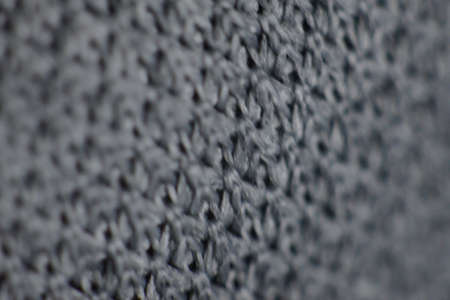 A closeup shot of a woven gray wool fabricの写真素材