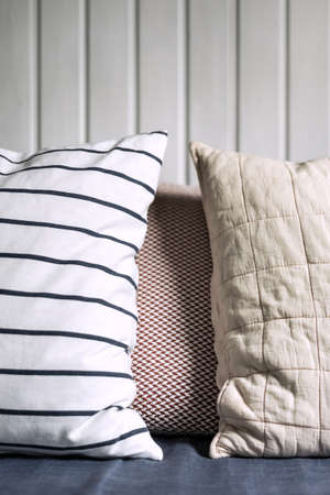 Two pillows next to each other with a white background