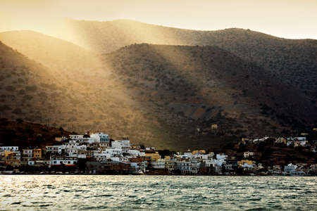 A landscape shot of the sun shining on Mavrikiano village in Crete island, Greece