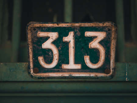 A close up shot of a gate number with green and white colors showing 313の写真素材