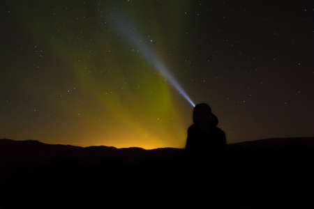 Beautiful shot of a lighthouse beacon spotlighting in the starry night