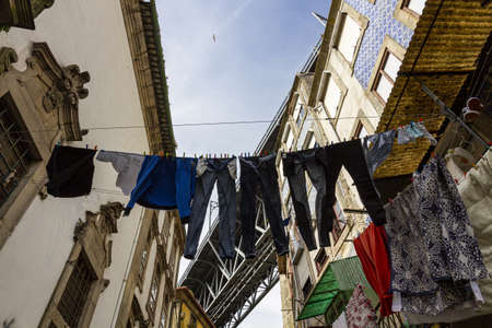 under the bridge in Porto with clothes hanging from the ropeの写真素材