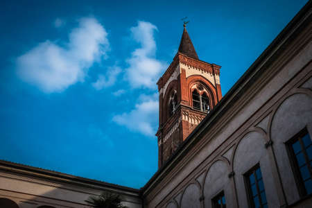 A low angle shot of a bell tower with blue sky in the background at daytimeの写真素材