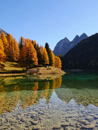 A breathtaking shot of a reflective lake on a mountain landscape background