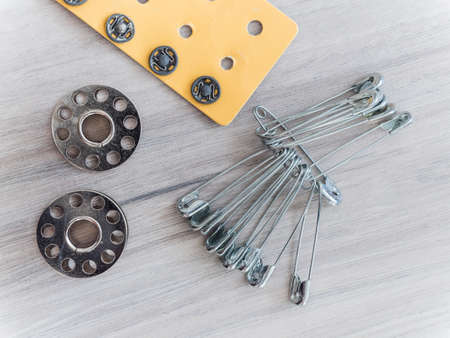 A closeup shot of sewing utensils on a wooden surfaceの写真素材