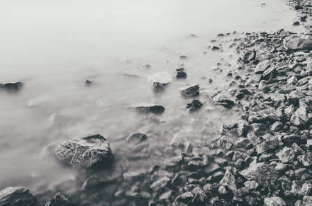 A closeup of rocks at the coast of the seaの写真素材