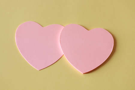 Pink hearts on a yellow background with space for text - Valentine's Dayの写真素材