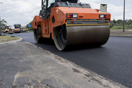 A group of road-rollers on the fresh asphalt under the sunlight at daytime