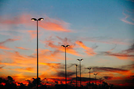 A beautiful shot of street lights with red and blue sky in the background